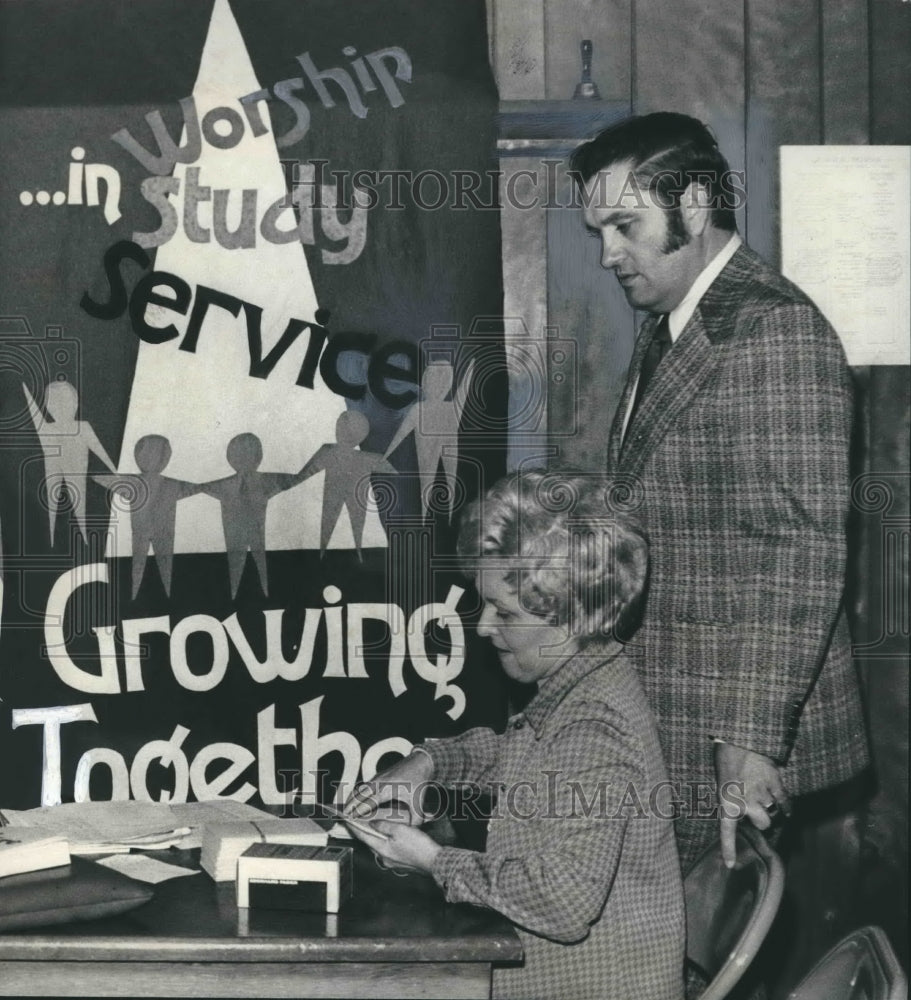 1976, Reverend and Mrs. Elvis North tabulating pledge cards at church - Historic Images