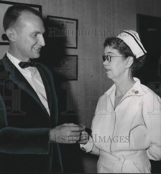 1959 D. O. McCluskey gives Miss Parks 35 year pin for hospital work - Historic Images