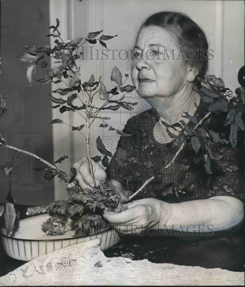 1965, Clubwoman Mrs. H. S. Miller with floral arrangement - abno07746 - Historic Images