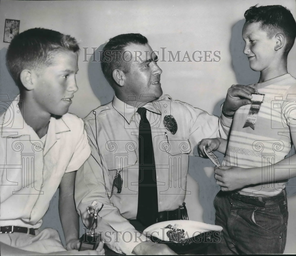 1956 Louis Elmore receives award from Officer B. D. McClesky Jr. - Historic Images
