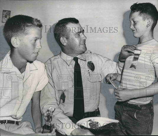 1956 Louis Elmore receives award from Officer B. D. McClesky Jr. - Historic Images