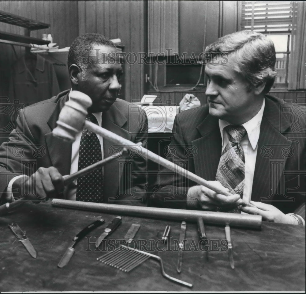 1975, Boys Adviser T. J. Hill, Principal Billy Marsh examine weapons - Historic Images