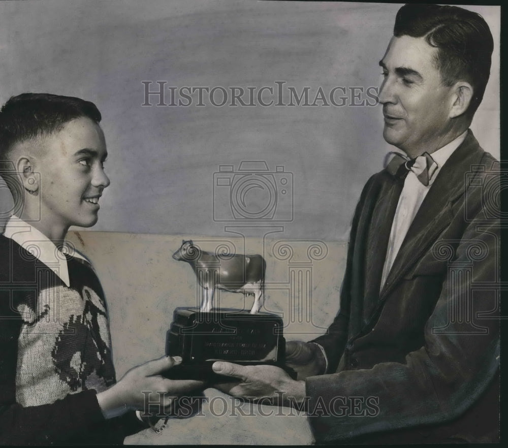 1950, Edward Grob receives model of Guernsey cow by H. H. Logue - Historic Images