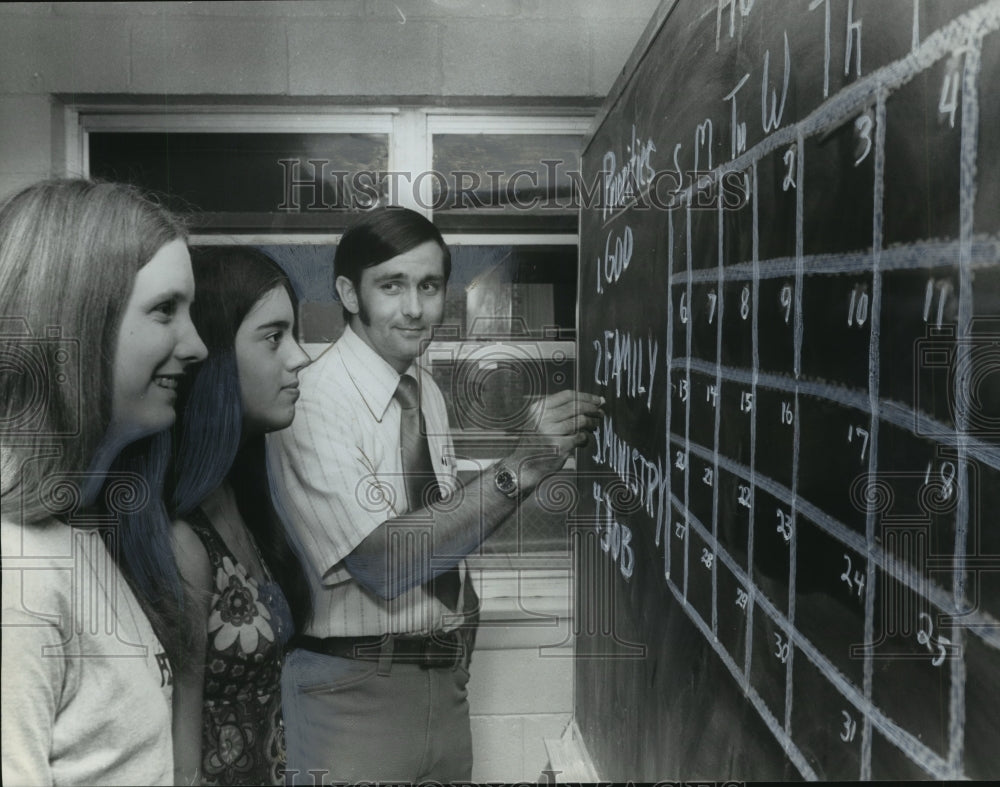 1972, Church Worker David Legg Explains Priorities to Girls - Historic Images