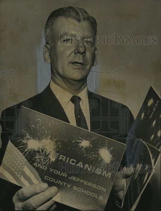 1963 Superintendent Kermit Johnson displays Americanism booklets - Historic Images