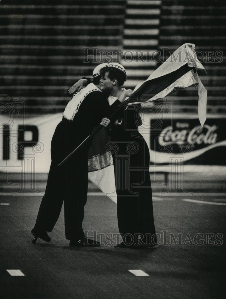 1984 Press Photo Members of Nighthawks Drum &amp; Bugle hug before performance - Historic Images