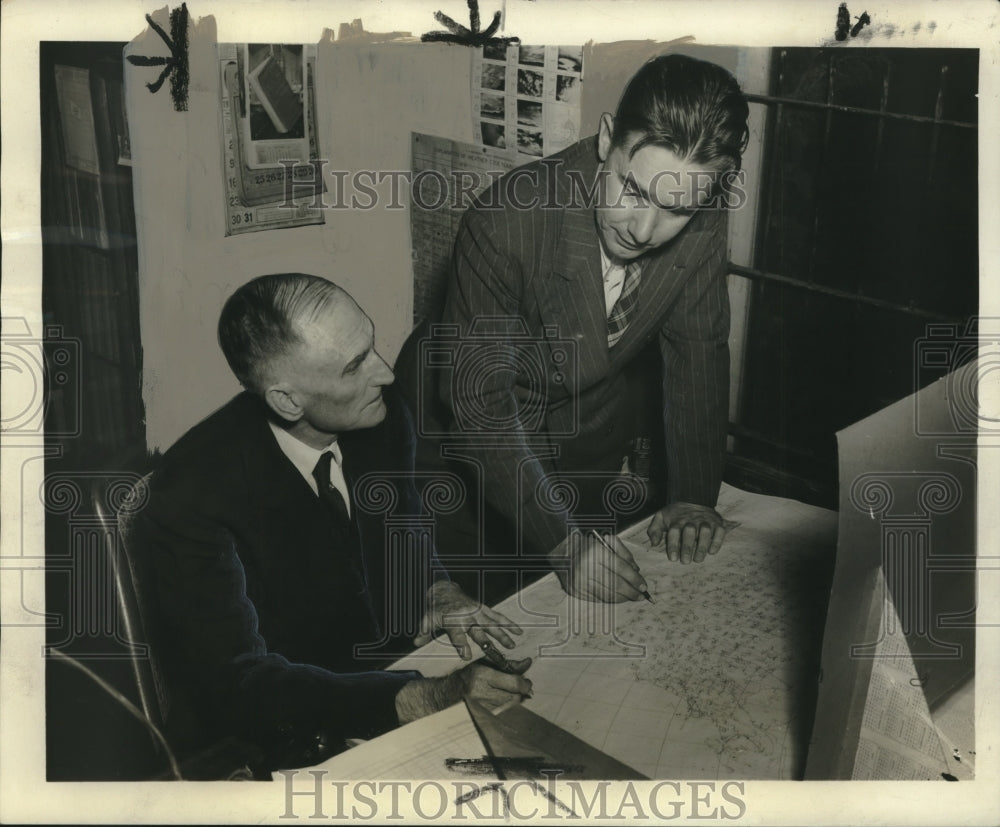 1945, Meteorologists Edgar Horton, Charles Bradley examining map - Historic Images