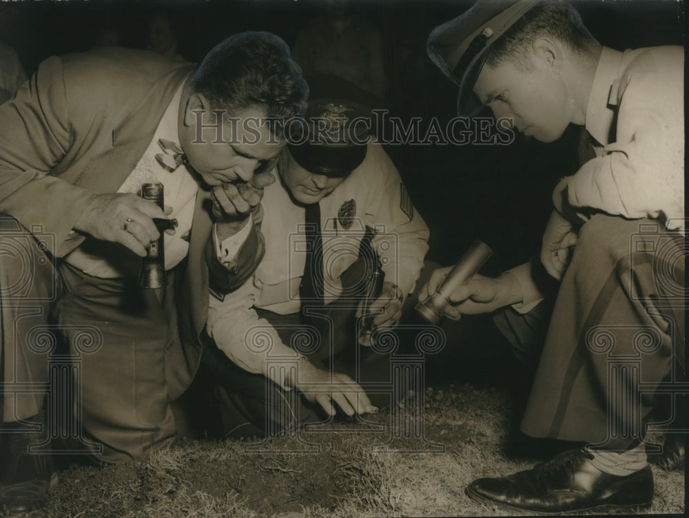 1955 Police examine hole blown in front yard of house due to strike - Historic Images