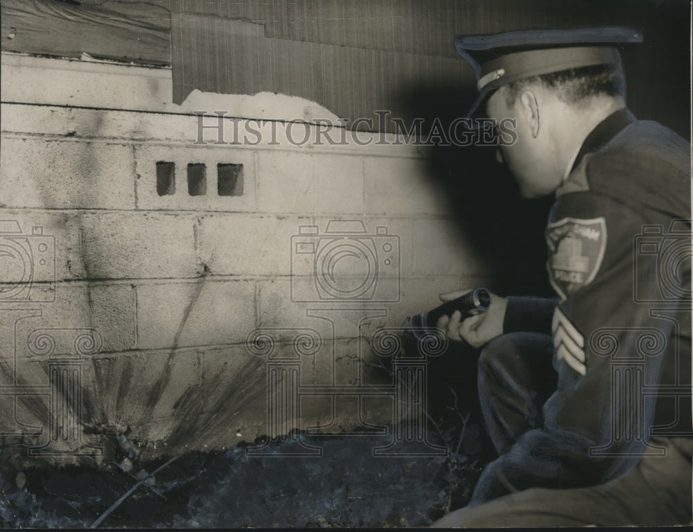 1955 Officer inspects damage to Phillip's home from striker's bomb - Historic Images