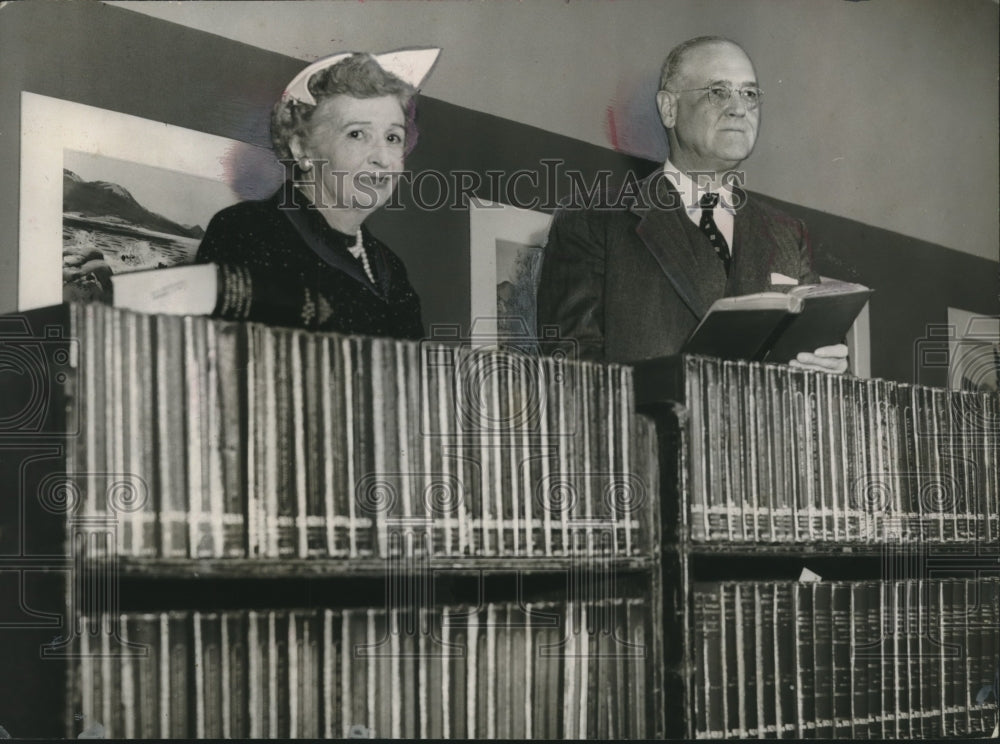 1954, Mr. &amp; Mrs. William M. Spencer with rare English books of names - Historic Images