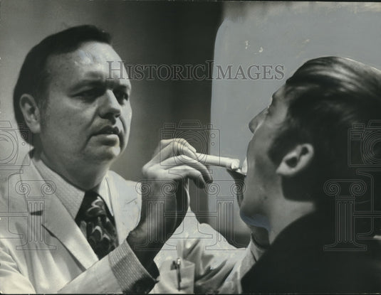 1973, Dr. George Rudd Examining Patient - abno10684 - Historic Images