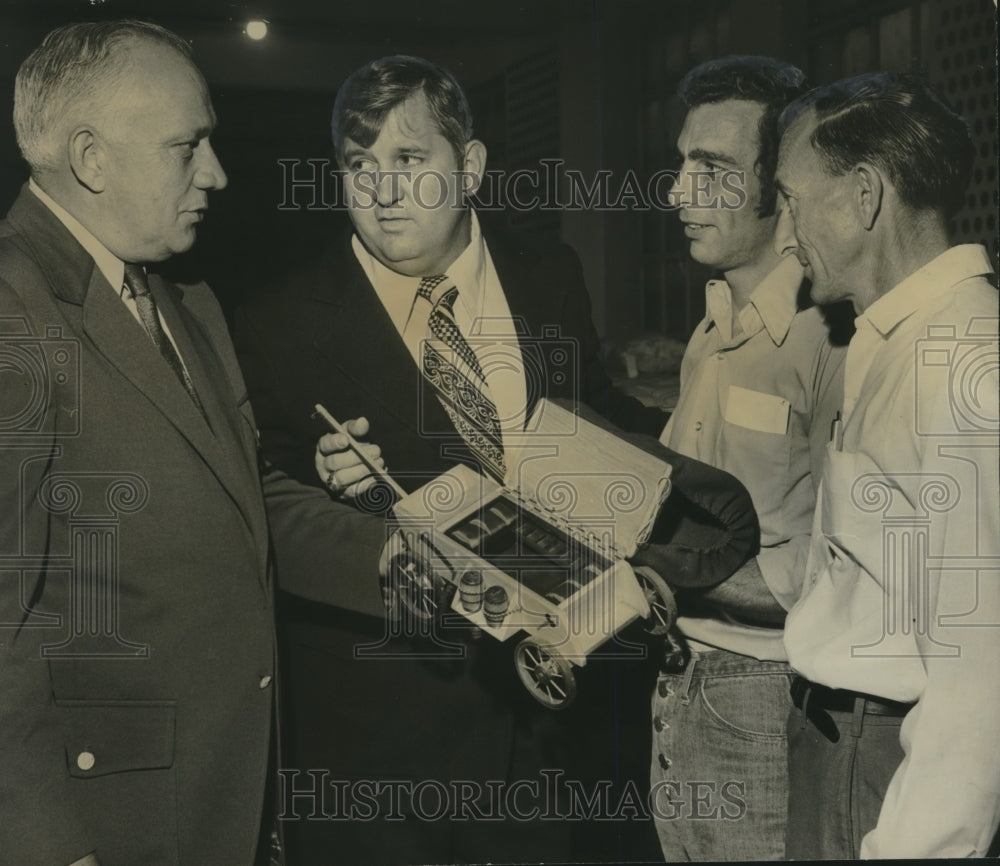 1973, L.B. Sullivan discusses prison handicrafts with 3 other men - Historic Images