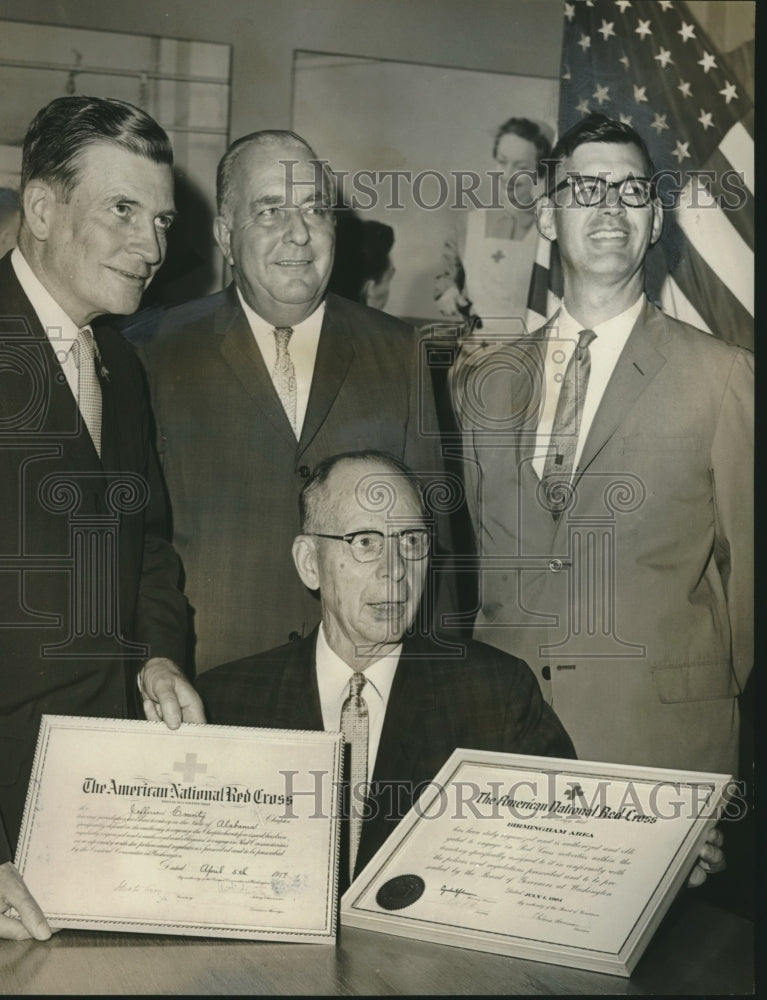 1964, Joseph Greene &amp; other Red Cross members examine charters - Historic Images