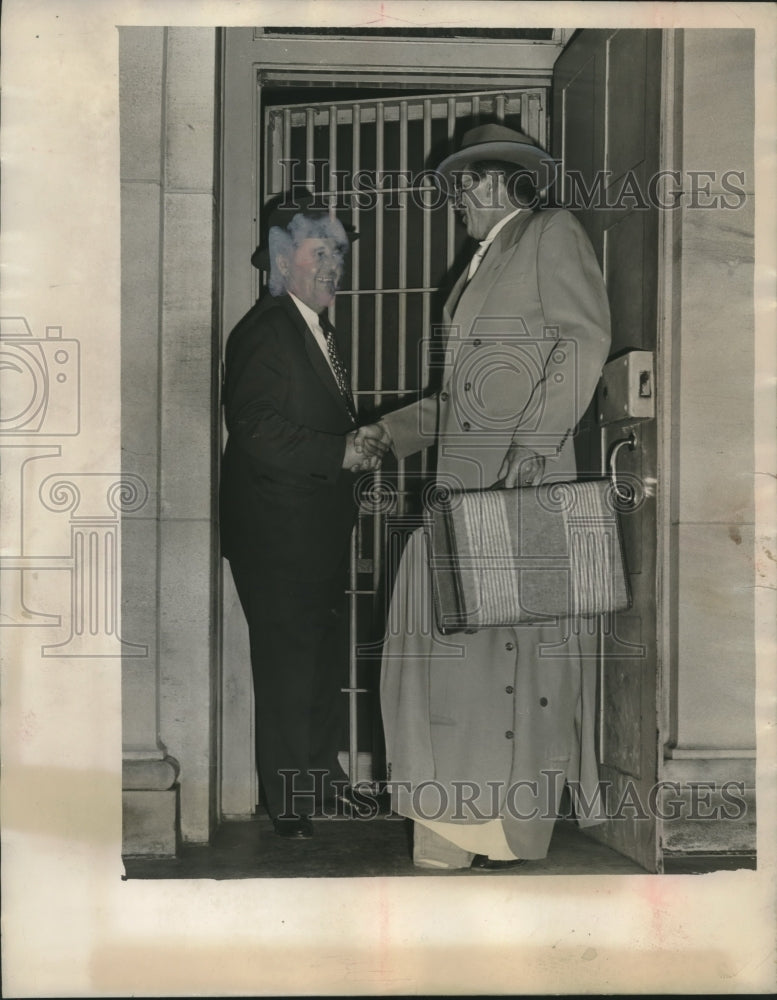 Press Photo Two Men Shake Hands in Building - abno11195 - Historic Images