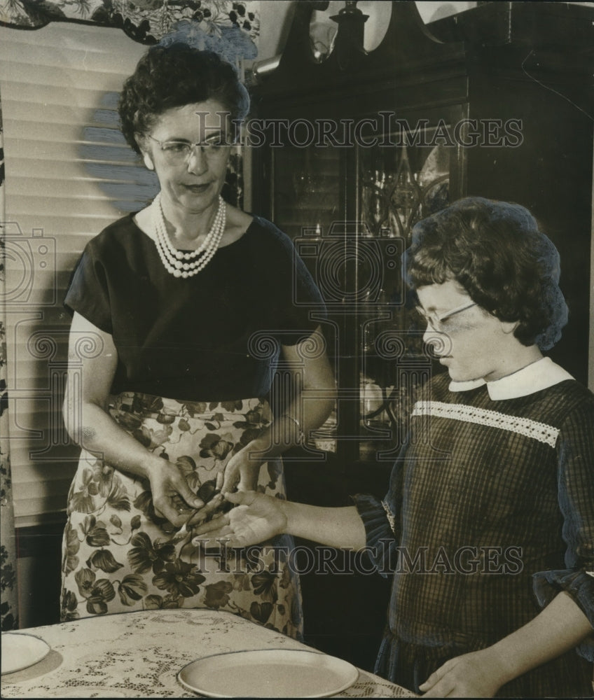 1962, Mrs. Elton G. Terry and daughter Kay set table in farm home - Historic Images