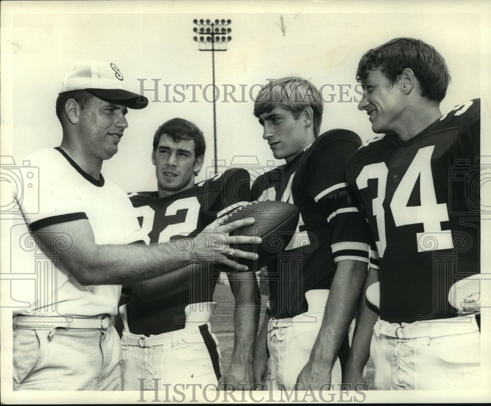 1970 Backfield coach John Patty talks with defensive backs - Historic Images