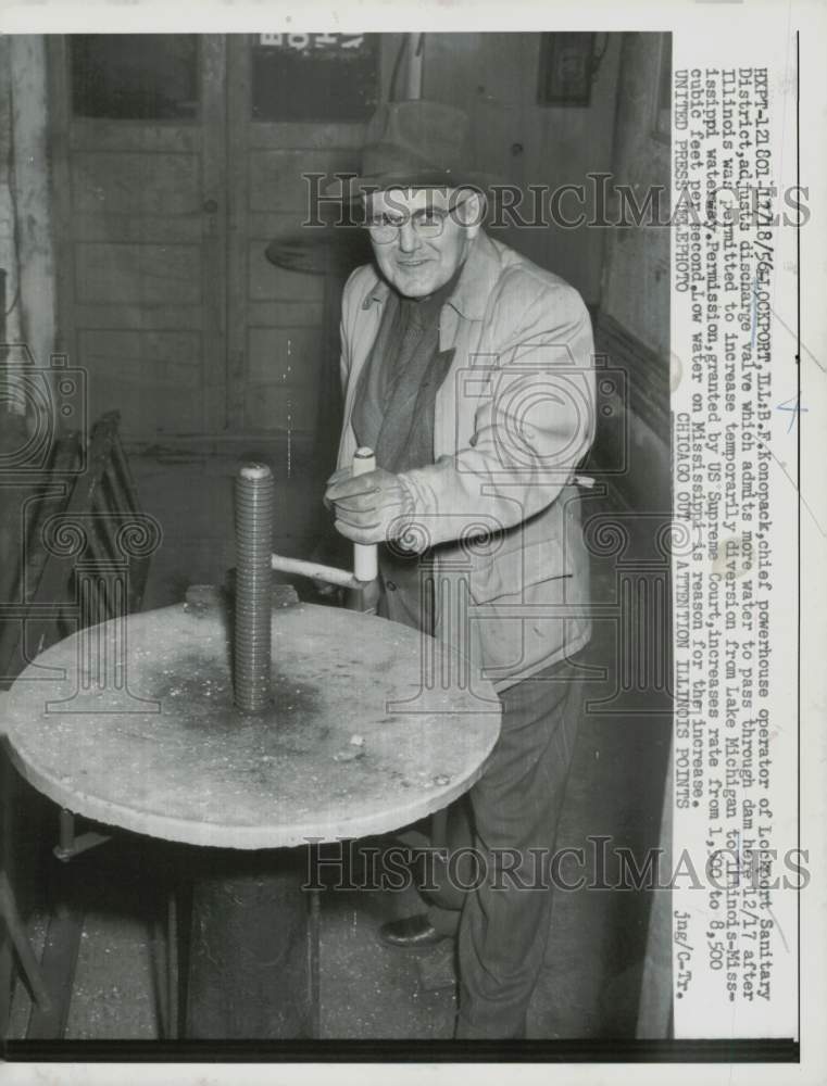 1956 Press Photo B.F. Konopack adjusting discharge valve at Lockport, Illinois- Historic Images