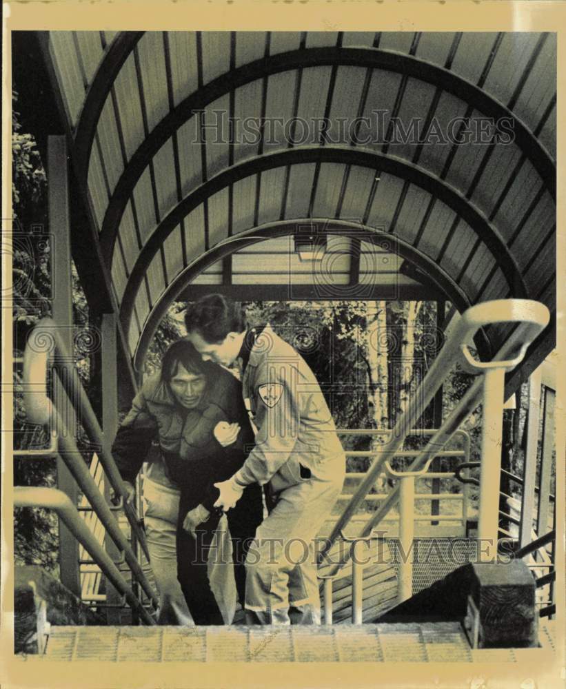 1990 Press Photo Scott Moon Helping Theo Atchak Climb Staircase in Anchorage- Historic Images