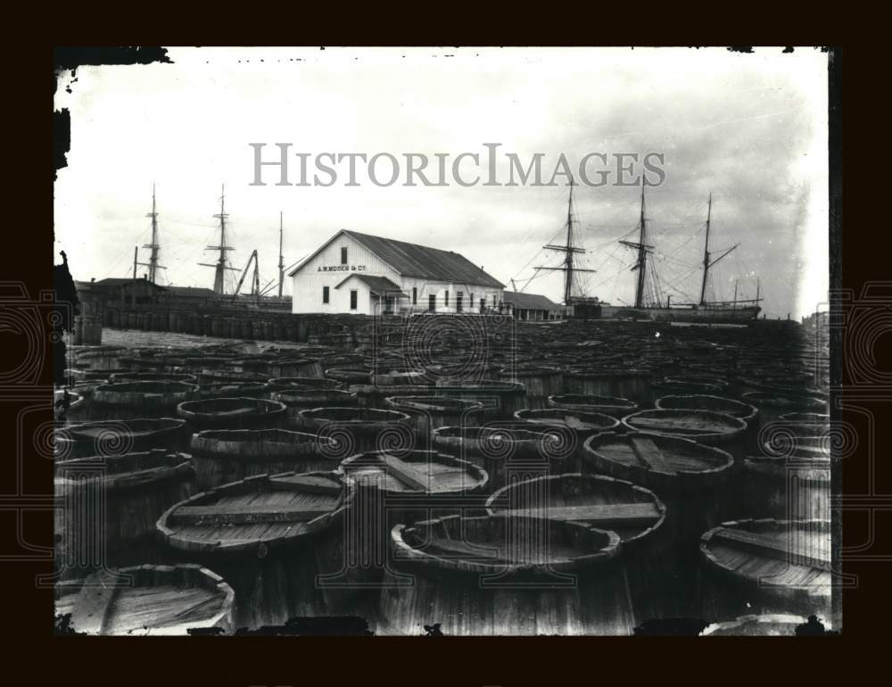 Press Photo Sea of Barrels on Dock with Ships in Background - amrx00451 - Historic Images