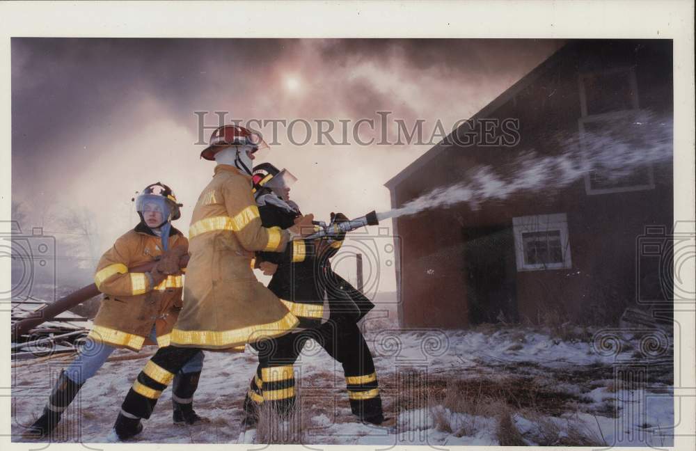 Press Photo Firemen in full gear spray water on a burning house - ctca02724- Historic Images