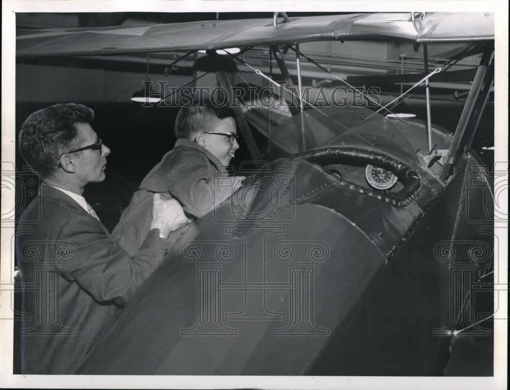 1961, Emerson Batdorf and Son Looking at Old Plane - cva00839 - Historic Images