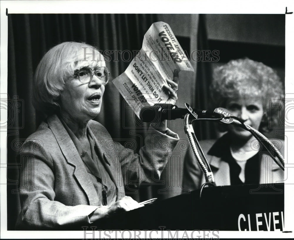 1988, Ann Chudner waves campaign literature at City Club debate - Historic Images