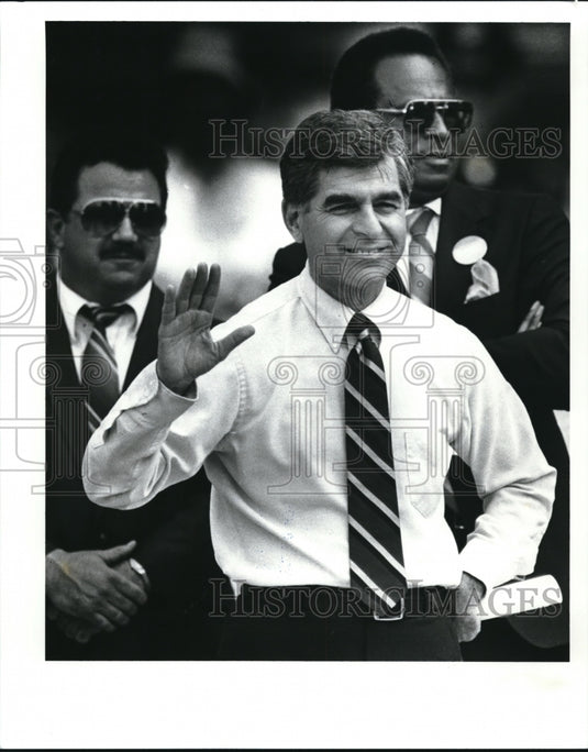 1988 Presidential candidate Michael Dukakis waves to some admirers - Historic Images