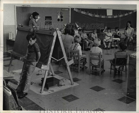 1972 Gerald J. Hastings hides from kinder class of Lincoln School - Historic Images