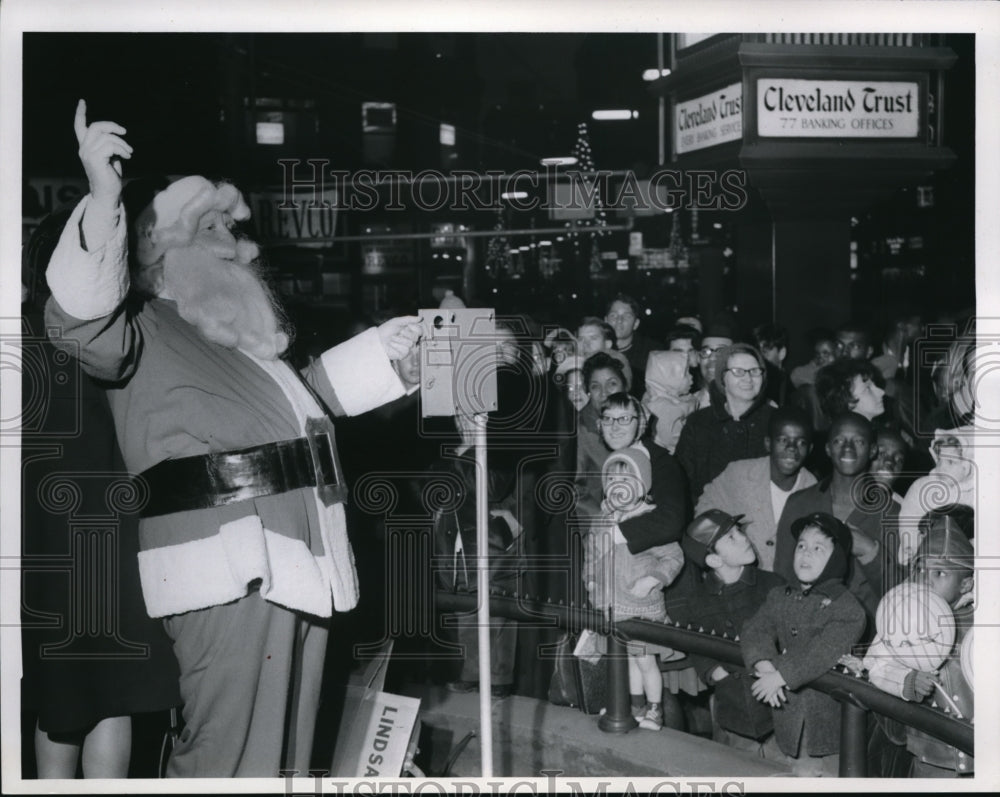 1966 Santa flicks switch lights on for Christmas from Euclid E 9th - Historic Images