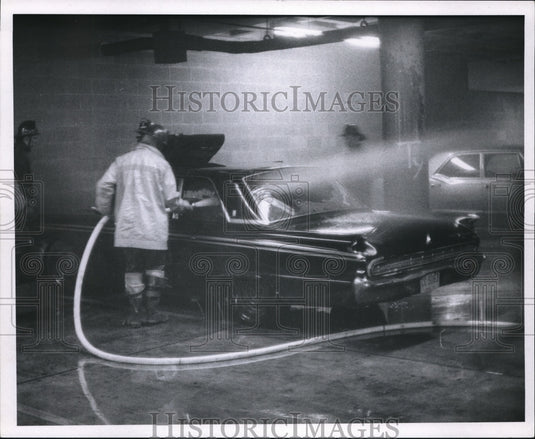 1970 The fireman puts out fire in the car at the school garage - Historic Images