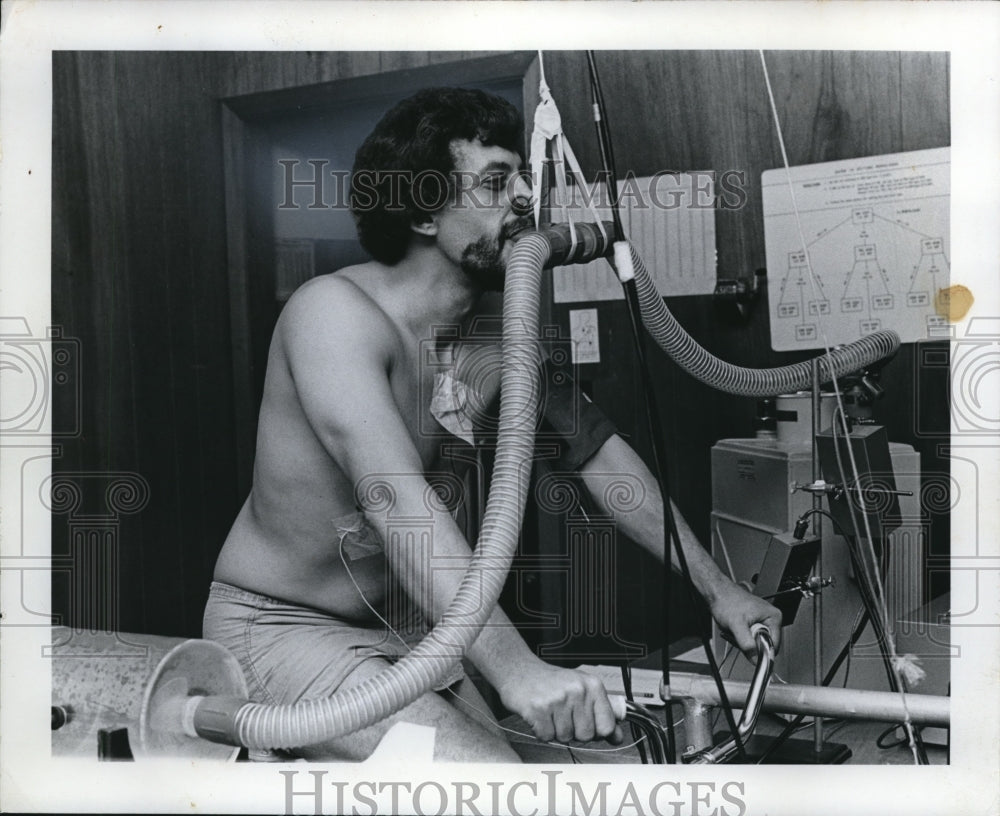 1974 Angelo Coulis of Kent State U. undergoing lung capacity test. - Historic Images