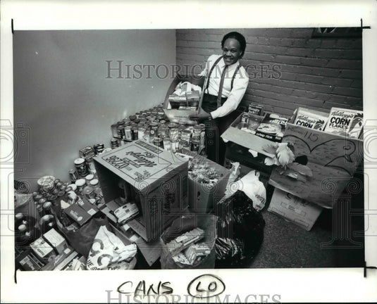 1990 Press Photo Ralph Poole poses in office at WZAk with canned food-Historic Images