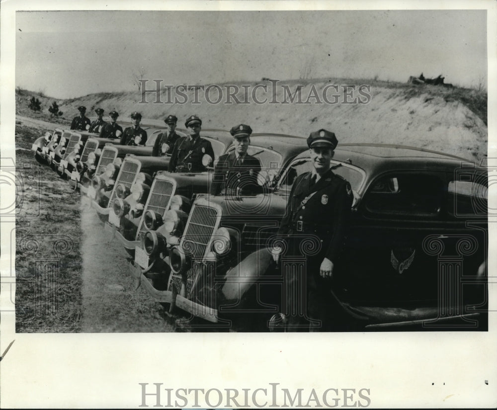 1968 Squad of patrolmen posed beside their 1935 Ford cruisers - Historic Images