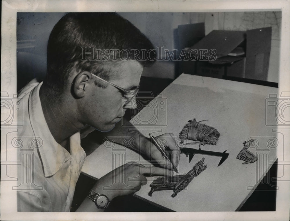 1960, Dr. Douglas W. Schwartz with the artifacts made by the Indian - Historic Images