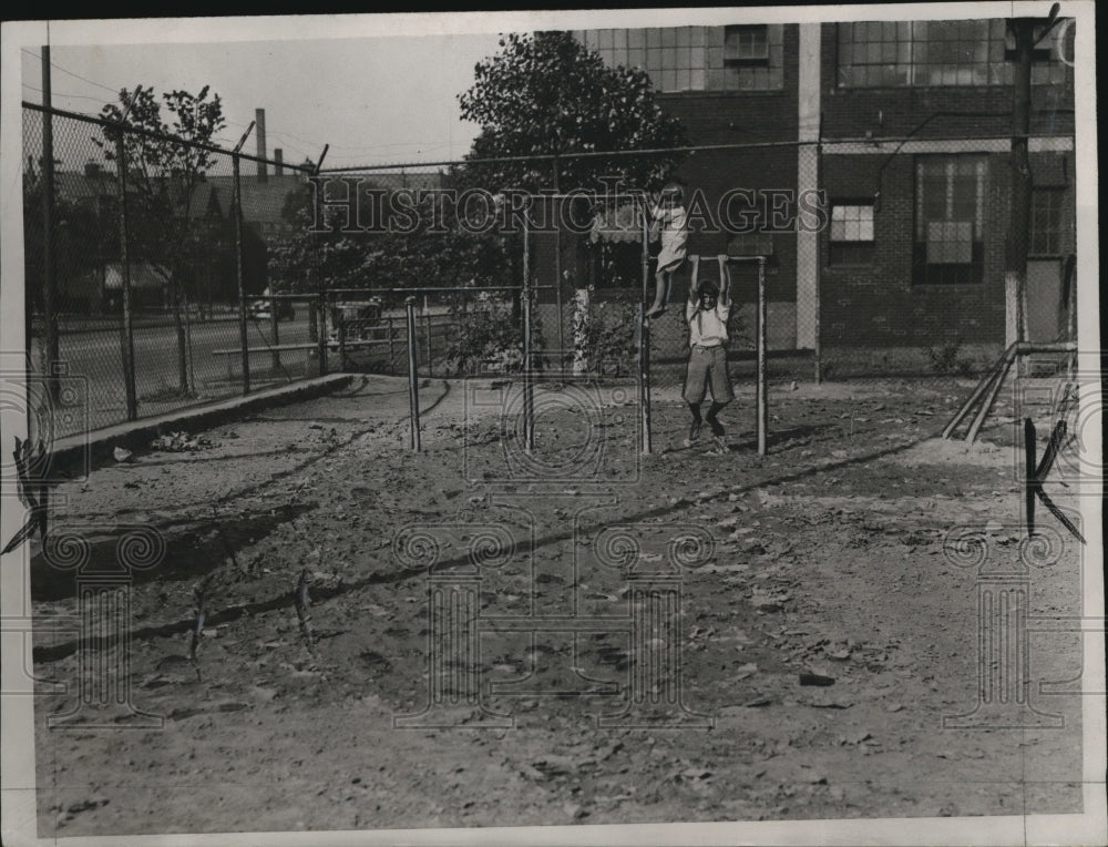 1933 Kenneth Frobeg and Frank Ketechaven on the broken swing - Historic Images