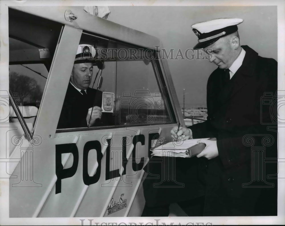 1964 Mel Horace applies Shield of Safety to Cleveland Police boat - Historic Images