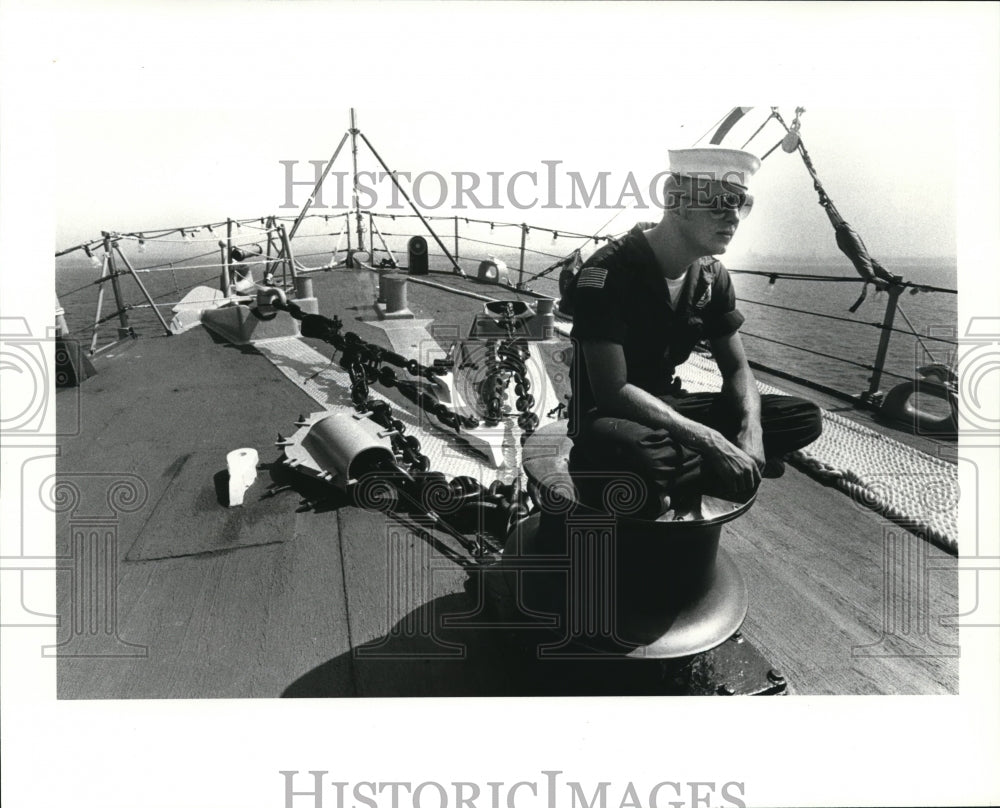 1984 Press Photo John Olson seated on the capstan on the for-deck - Historic Images