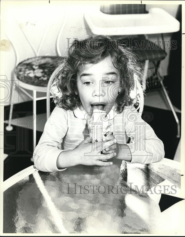 1987 Press Photo Leigh Ann Adamson tries vanilla ice cream at Penguin. - Historic Images