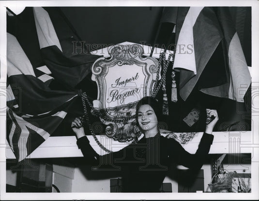 1960 P. Solin models a Spanish veil in a setting of imports at Halle - Historic Images