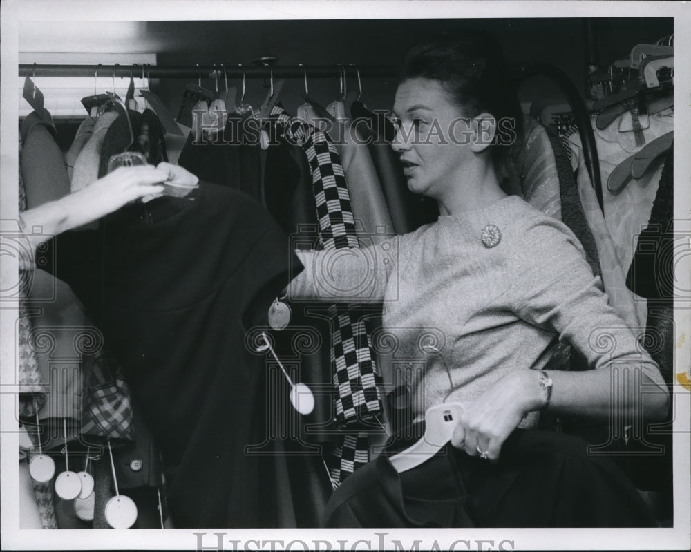 1966 Press Photo Employee fixing clothe&#39;s display on the rack at Halle Bros. CO. - Historic Images