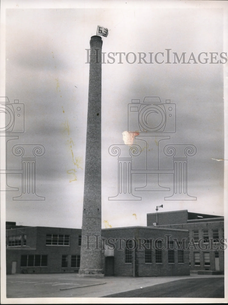 1962 Flag with 63 painted on it waves top Rocky River High&#39;s chimney - Historic Images