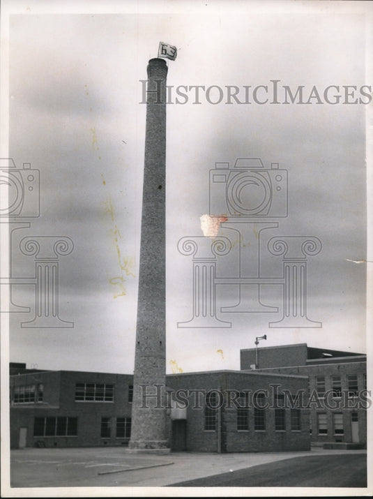 1962 Flag with 63 painted on it waves top Rocky River High's chimney - Historic Images