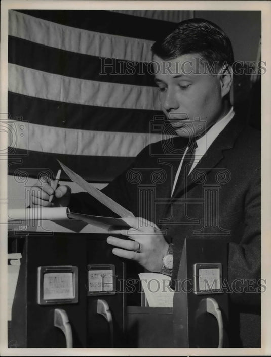 1963 Press Photo Reporter William C. Barnard, Checking Records - Historic Images