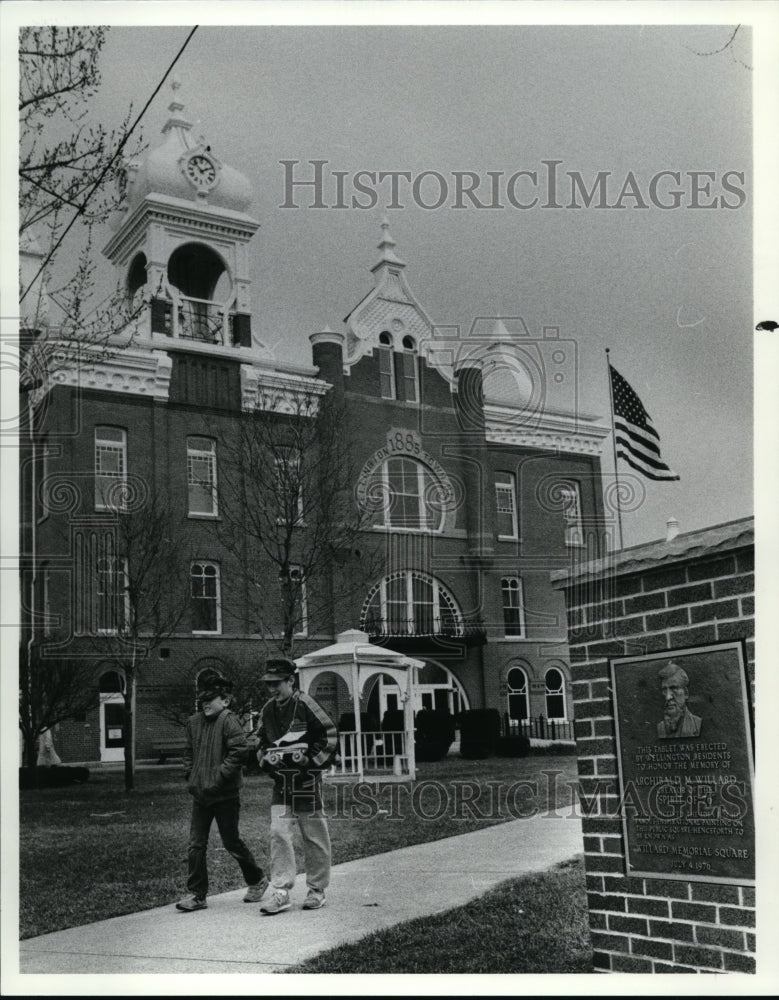 1985 Press Photo Two boys walk outside of the Wellington Town Hall building - Historic Images