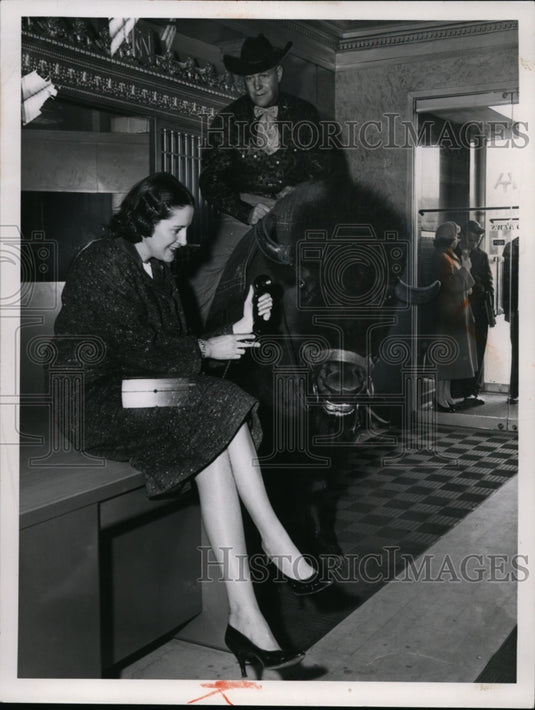 Press Photo Doris O'Donnell placing a telephone on a bull's ear - cvb09742 - Historic Images