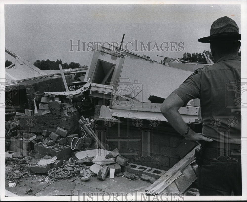1969 Press Photo State Highway Patrolman surveys-storm damages - cvb18216 - Historic Images
