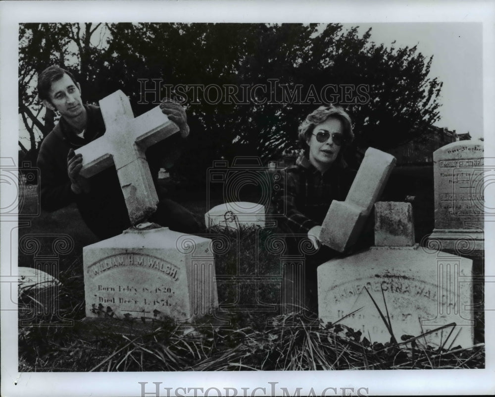 1979, Woman holding piece of broken tombstone. - cvb24434 - Historic Images