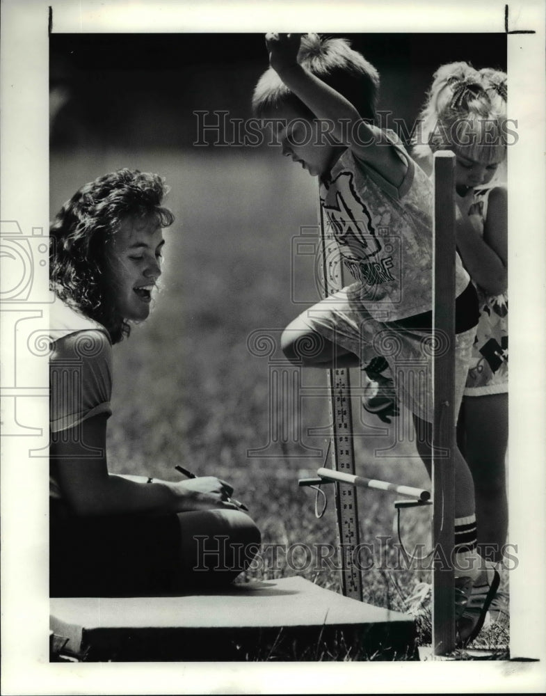 1990, Joey Gugliotta clears the bar at 12 inches in pee wee Olympics - Historic Images