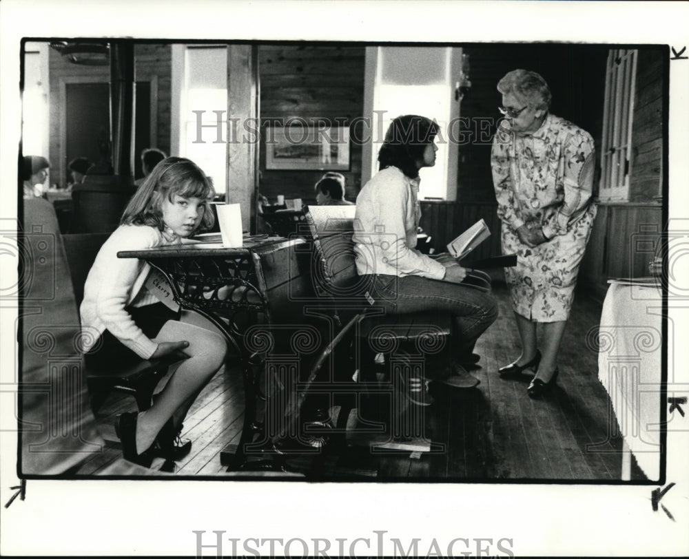 1984 Press Photo Adrienne Cherry sits while teachers give test to 7th grader. - Historic Images