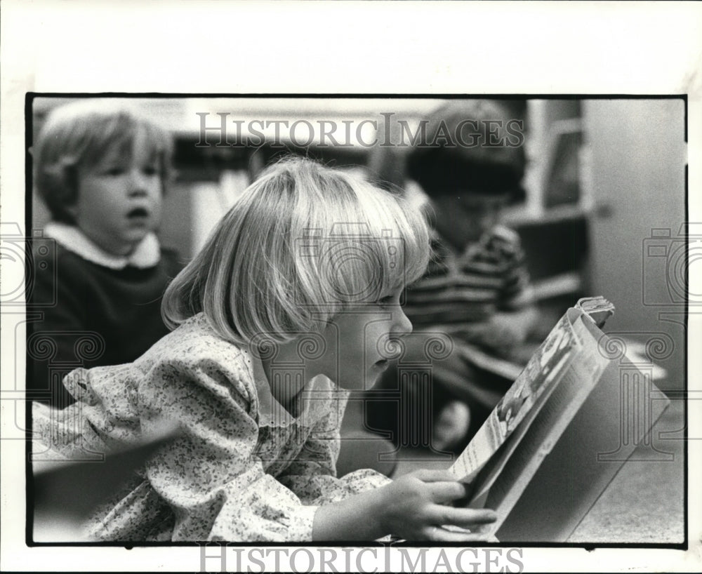 1983 Press Photo A Hathaway Brown pre-school student reads during their time - Historic Images